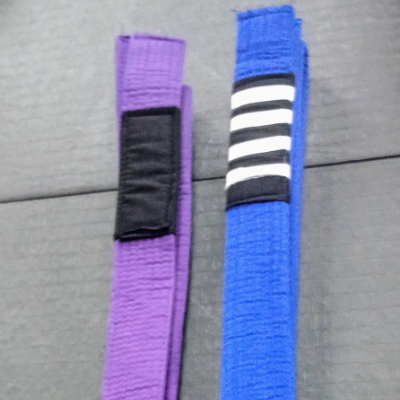 blue belt mma next to purple belt mma promotion